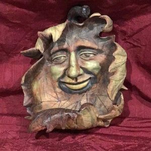Face in leaf outside wall hanging